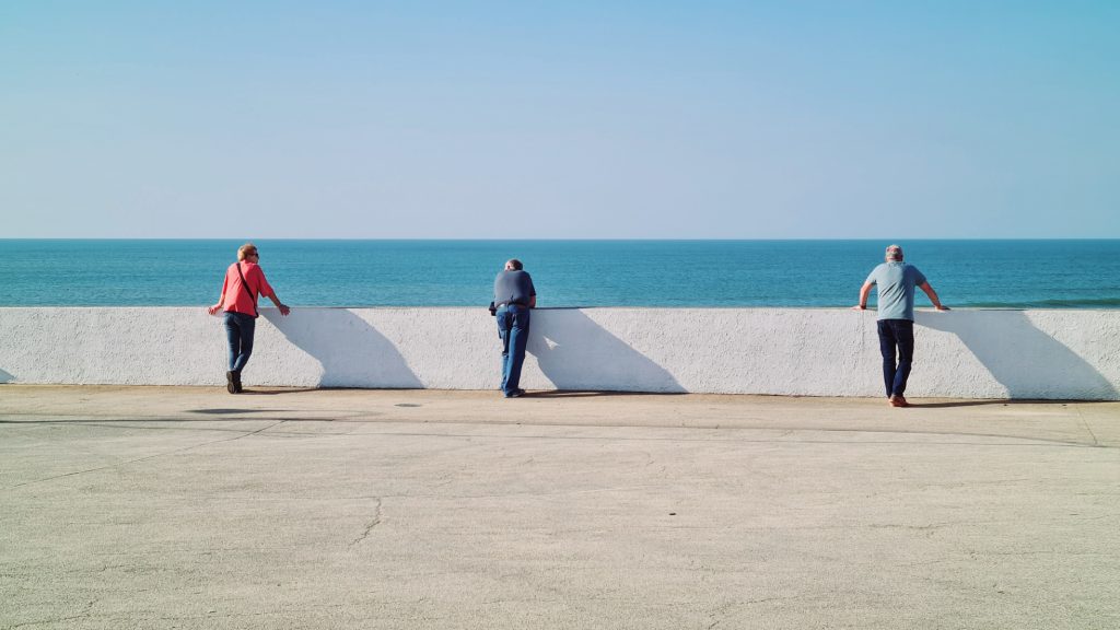 people looking over sea wall